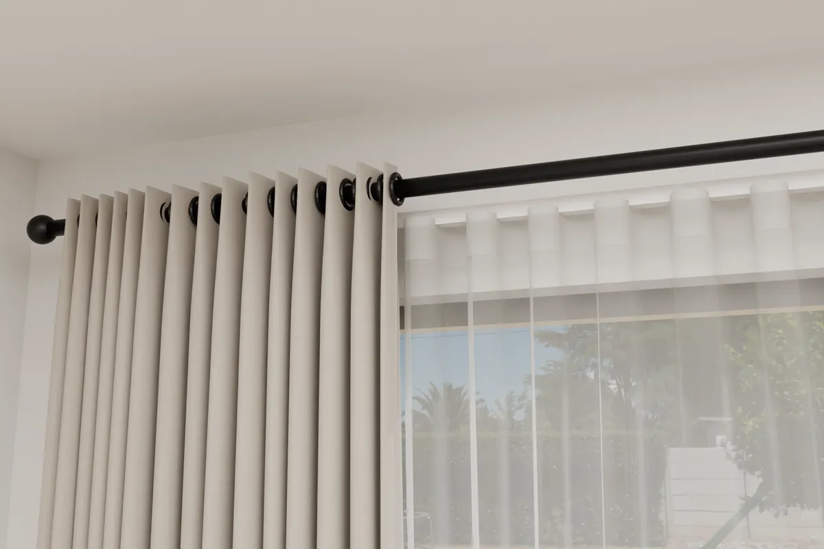 The top of an eyelet curtain close up, with the pole through its rings marked