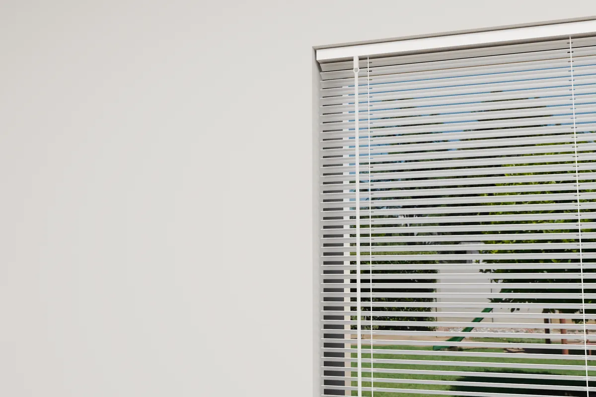 The top of a venetian blind close up, with the rail along its top marked